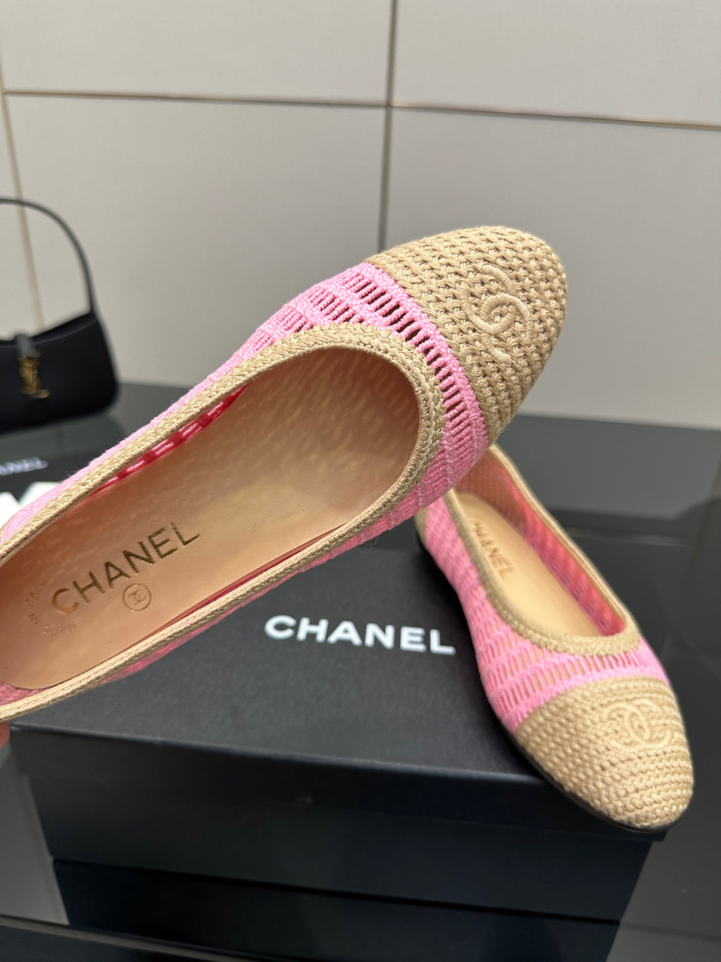 Women's Chanel ballet flats with beige footbed and pink trim, logo visible inside