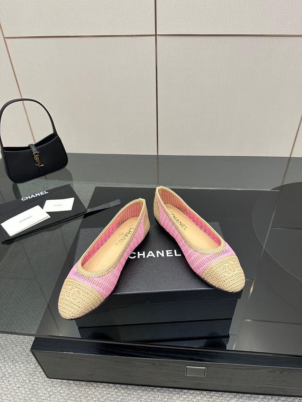Pair of women's Chanel ballet flats in beige crochet with pink edging, angled view