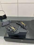 Black leather YSL thong sandals with gold logo on the front strap