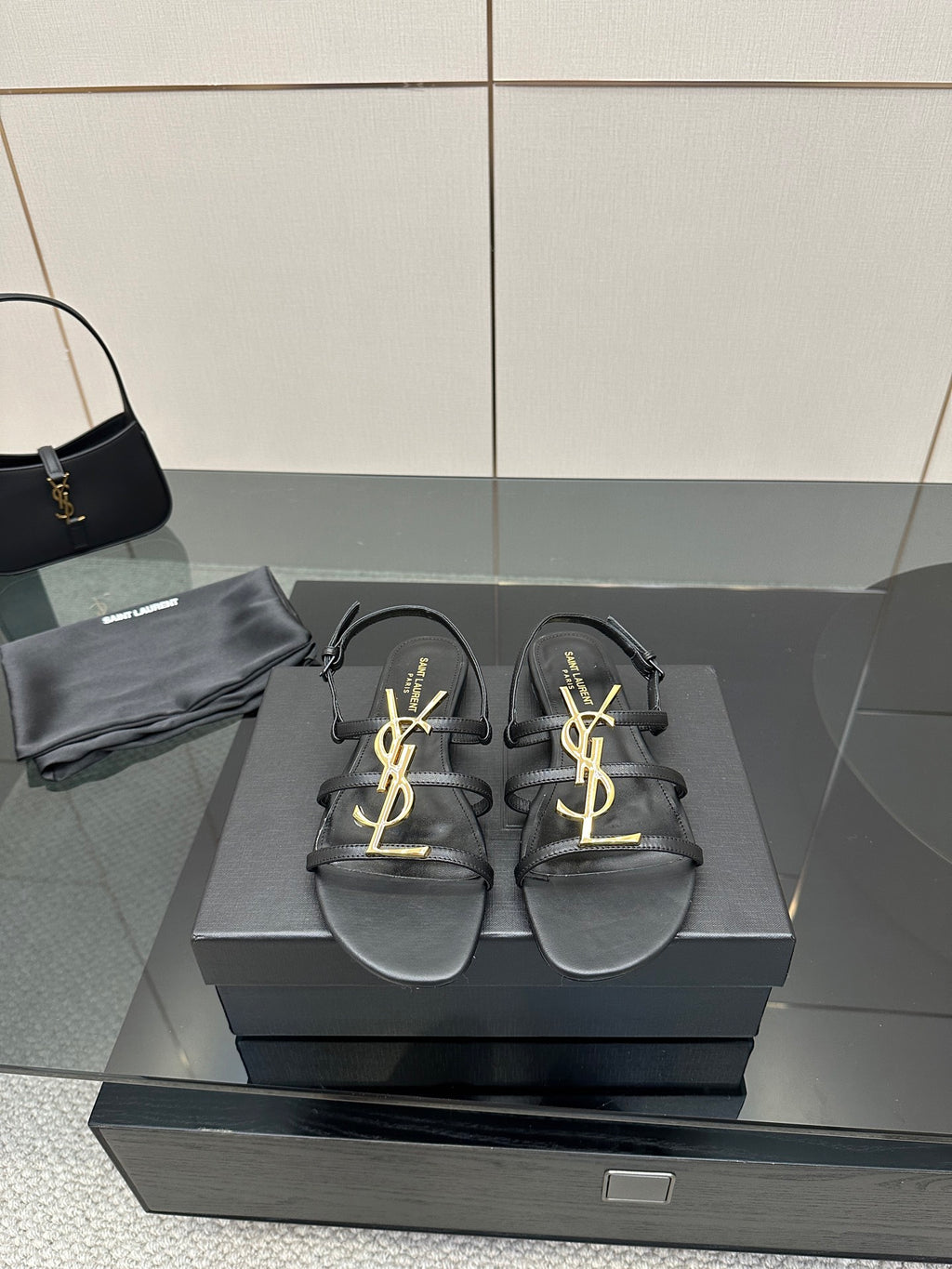 Black leather thong sandals with gold YSL logo on straps