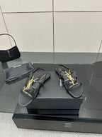 Black YSL thong sandals with gold logo on crossover straps