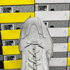 Light gray unisex running sneaker front view with lace-up and textured panel details