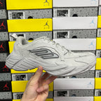 Light gray unisex running sneaker with mesh upper, lace-up, and chunky rubber sole