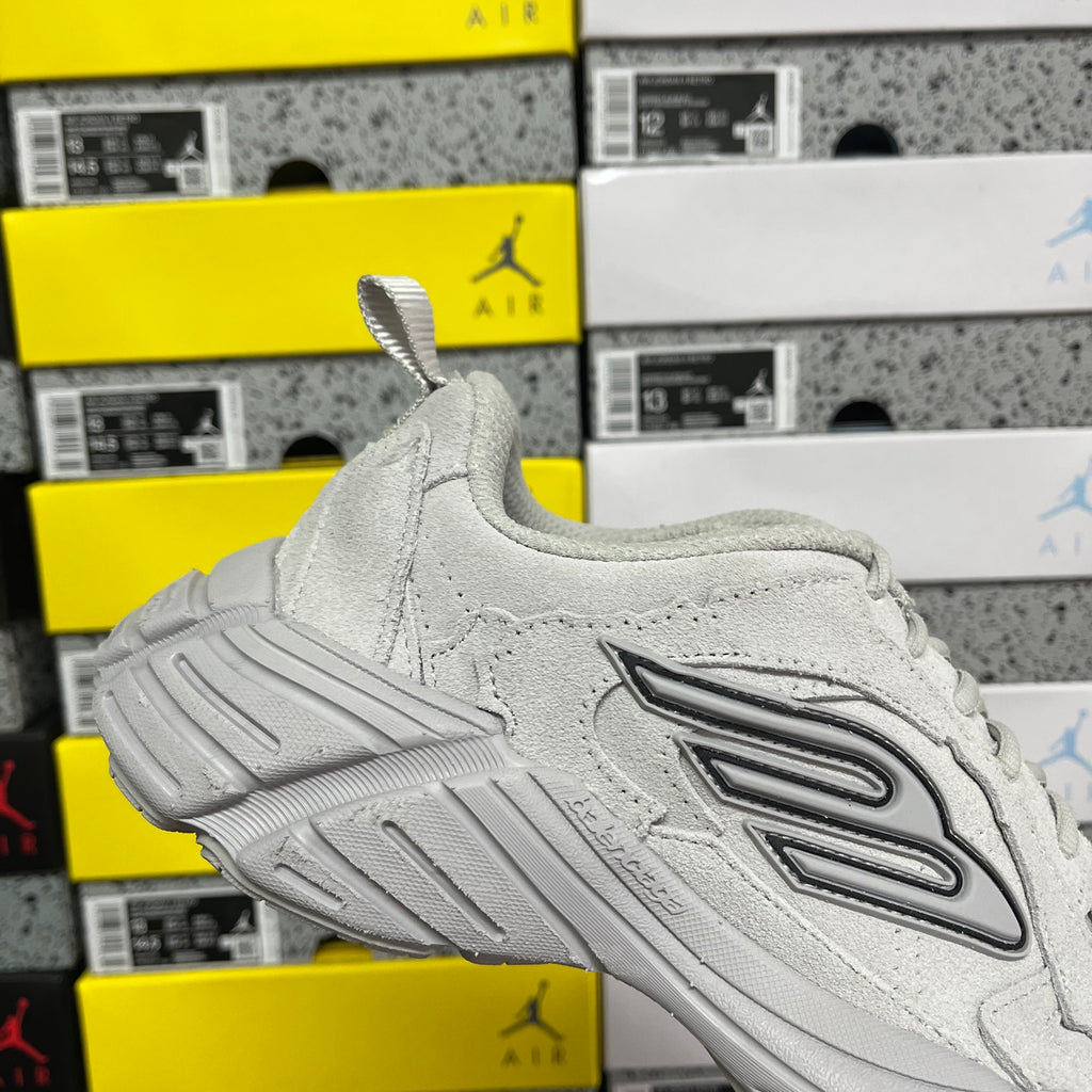 Light gray unisex running sneaker side profile with lace-up and patterned overlays