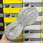 Light gray unisex running sneaker outsole with deep tread pattern and traction grooves