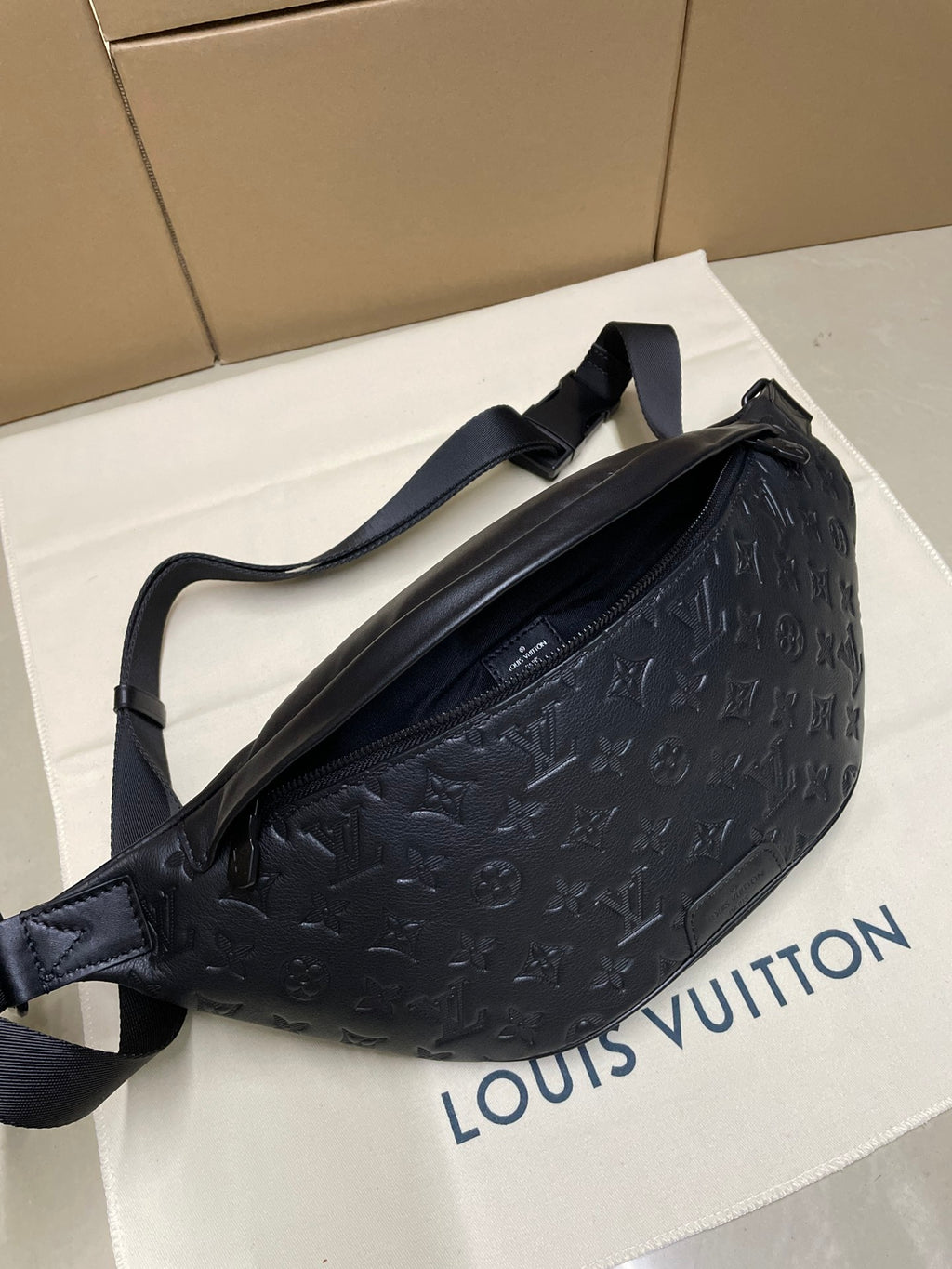 Men’s Louis Vuitton dark navy monogram sling bag, side view with adjustable strap