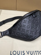Men’s Louis Vuitton monogram belt bag in dark navy, angled side with strap
