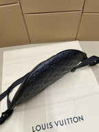 Men’s Louis Vuitton monogram sling bag in dark navy with curved silhouette
