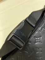 Men’s Louis Vuitton monogram crossbody bag close-up of buckle and strap