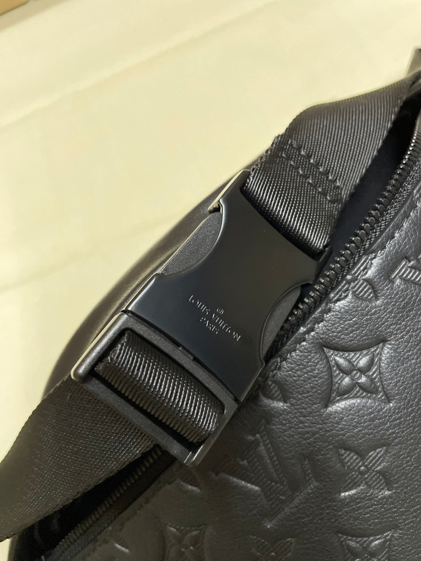 Men’s Louis Vuitton monogram crossbody bag close-up of buckle and strap