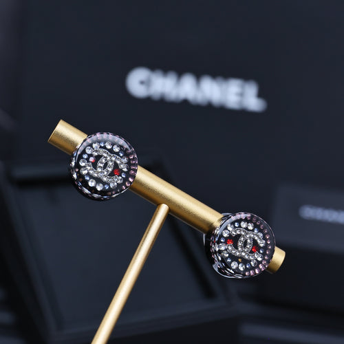 Round rhinestone stud earrings with gold posts and black enamel, sparkling stones