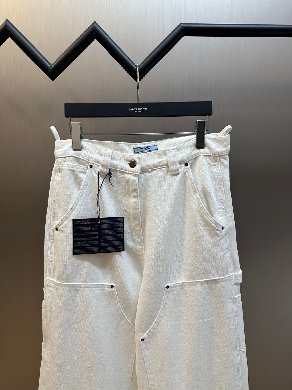 Off-white cargo pants with flap pockets and button front closure
