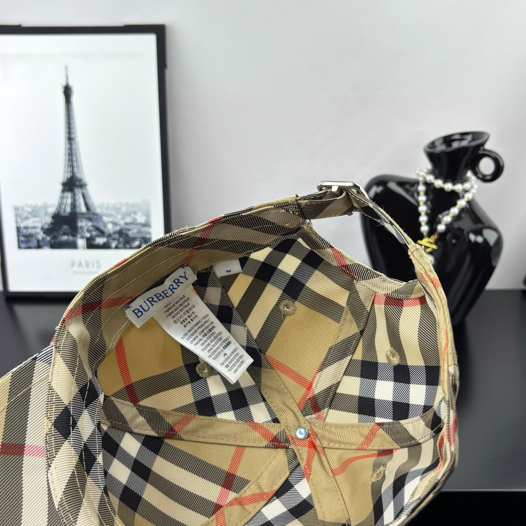 Burberry plaid baseball cap, beige interior with black-and-red check panels and clip strap.