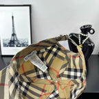 Burberry plaid baseball cap, beige interior with black-and-red check panels and clip strap.