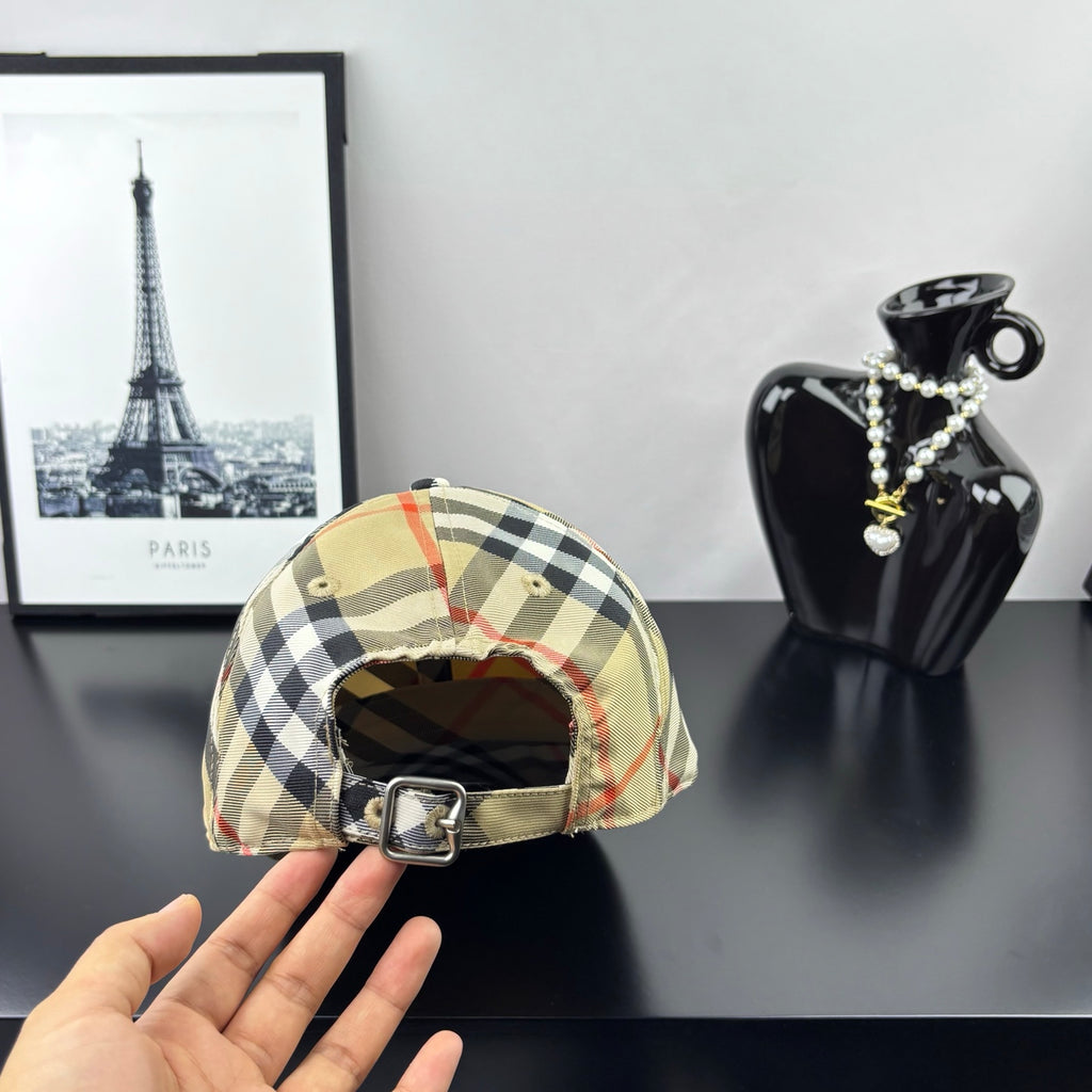 Burberry plaid baseball cap with beige, black, and red check pattern, adjustable strap.