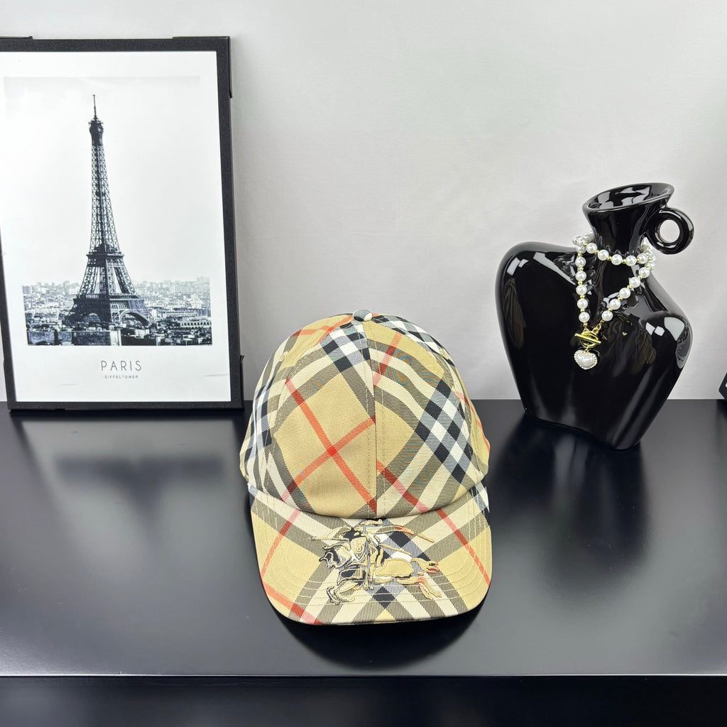 Burberry baseball cap in beige, black, and red plaid with curved brim and emblem front.