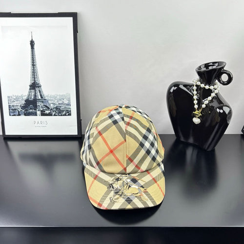 Burberry baseball cap in beige, black, and red plaid with curved brim and emblem front.