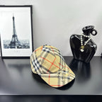 Burberry plaid baseball cap in beige and black with red lines, curved brim, side view.