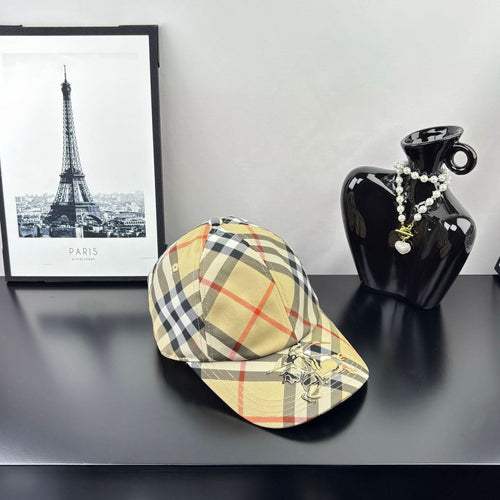 Burberry plaid baseball cap in beige and black with red lines, curved brim, side view.