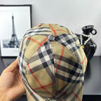 Burberry plaid baseball cap in beige with black-and-red check pattern, back button detail.