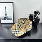 Burberry plaid baseball cap in beige, black, and red check pattern, front view.