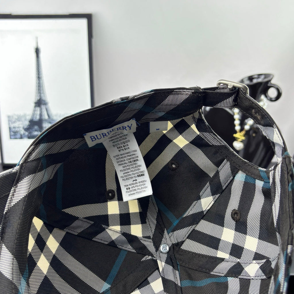 Burberry cap interior with woven label and dark/white plaid lining.