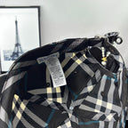 Burberry cap interior with woven label and dark/white plaid lining.