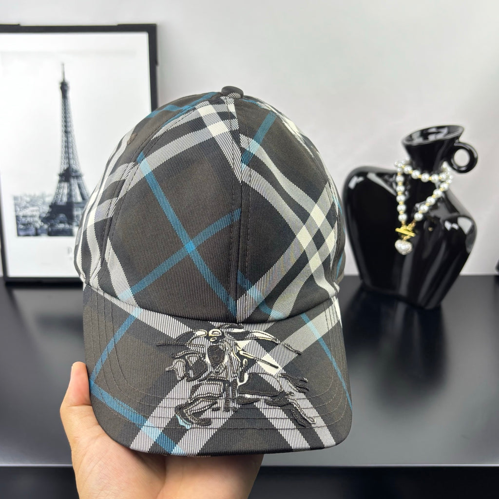 Burberry cap, dark gray and blue plaid, featuring a crest emblem at the front.