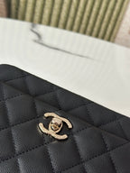 Chanel bag logo detail, black quilted leather with gold-tone CC emblem