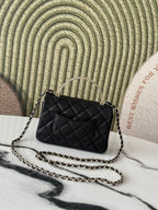 Chanel bag, black quilted leather with CC logo and long chain strap