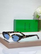 Bottega Veneta sunglasses with tortoise-pattern frames and dark tinted oval lenses