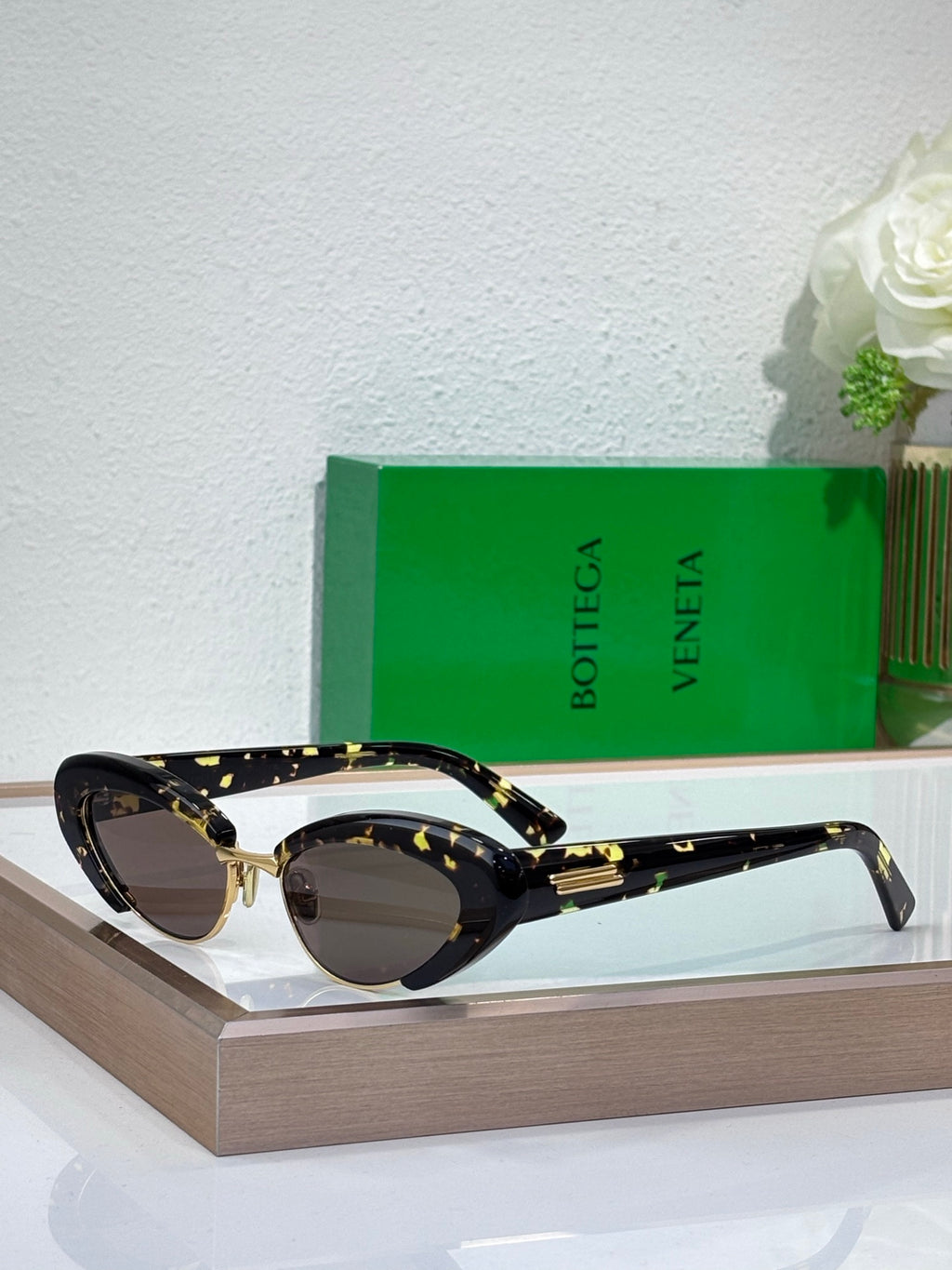 Bottega Veneta sunglasses with tortoise-pattern frames and dark tinted oval lenses