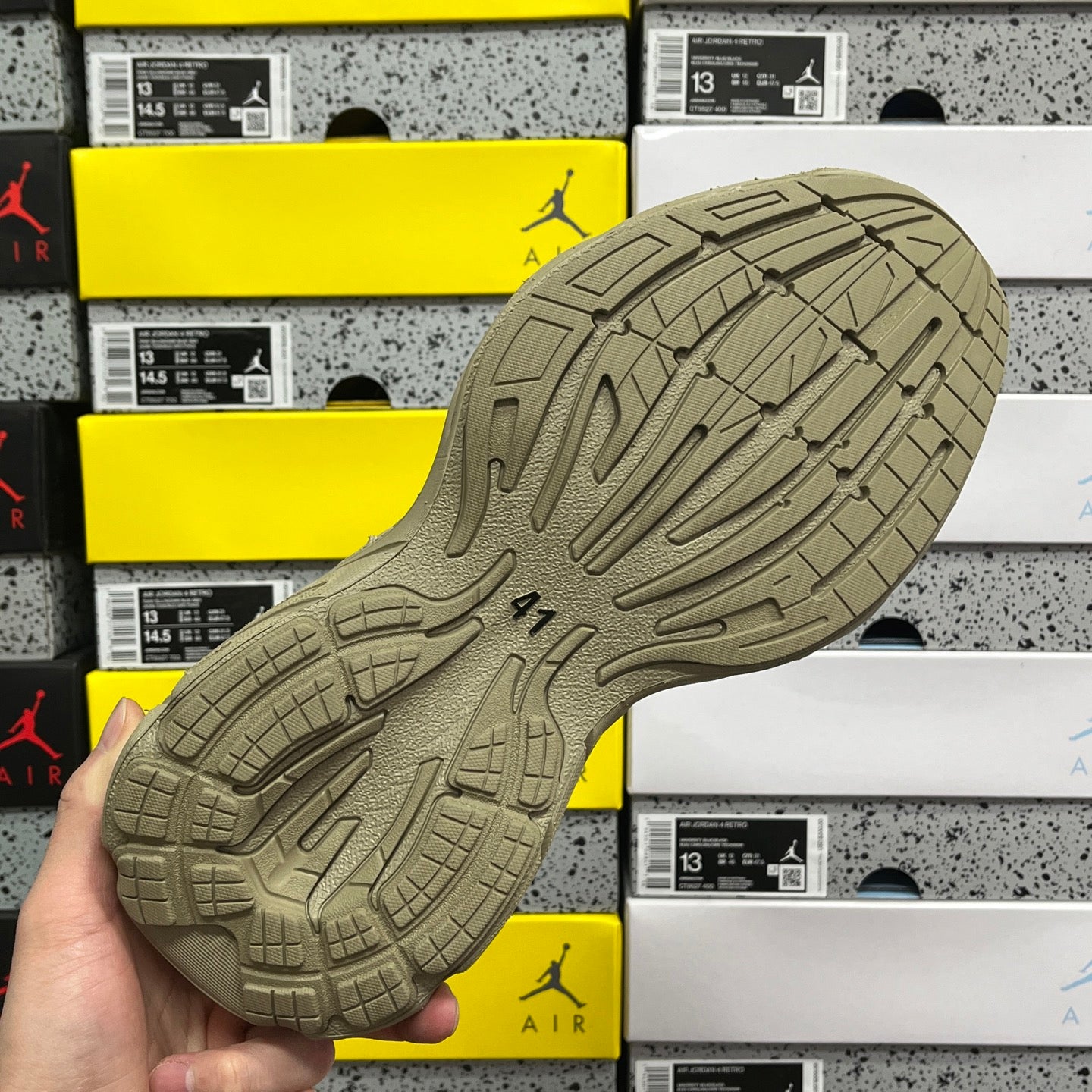 Beige rubber outsole with grid tread pattern and traction grooves