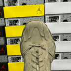 Beige suede sneaker upper with lace eyelets and stitched panel