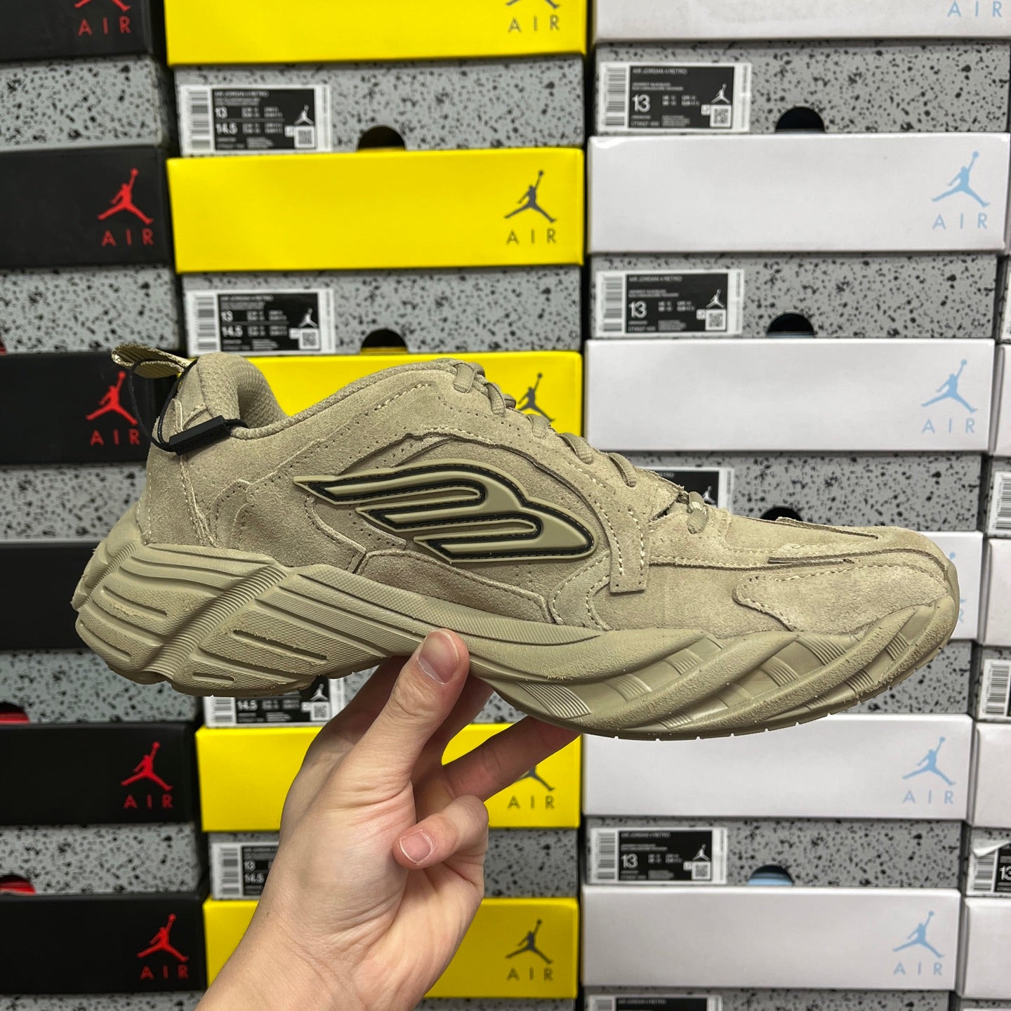 Beige suede lace-up sneaker with side logo and thick cushioned sole