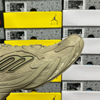 Beige suede sneaker side profile with molded logo detail and ribbed sole