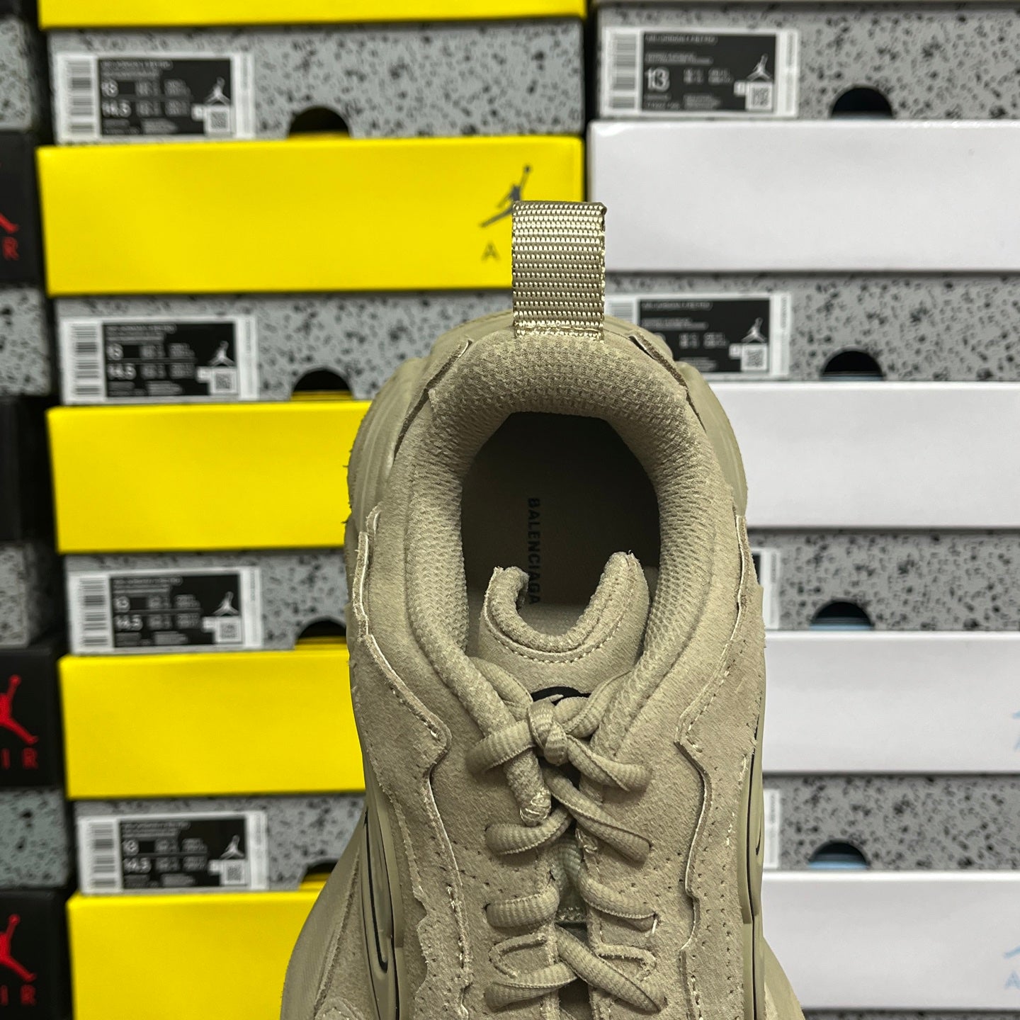 Beige suede sneaker heel collar opening with lace-up close-up