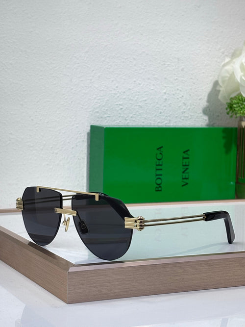 Sunglasses with dark blue gradient lenses and gold-tone metal frame, tortoise temples