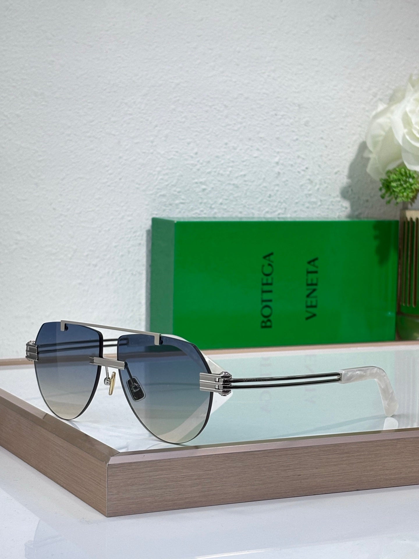 Sunglasses with dark lenses and gold-tone metal frame, tortoise-look side arms