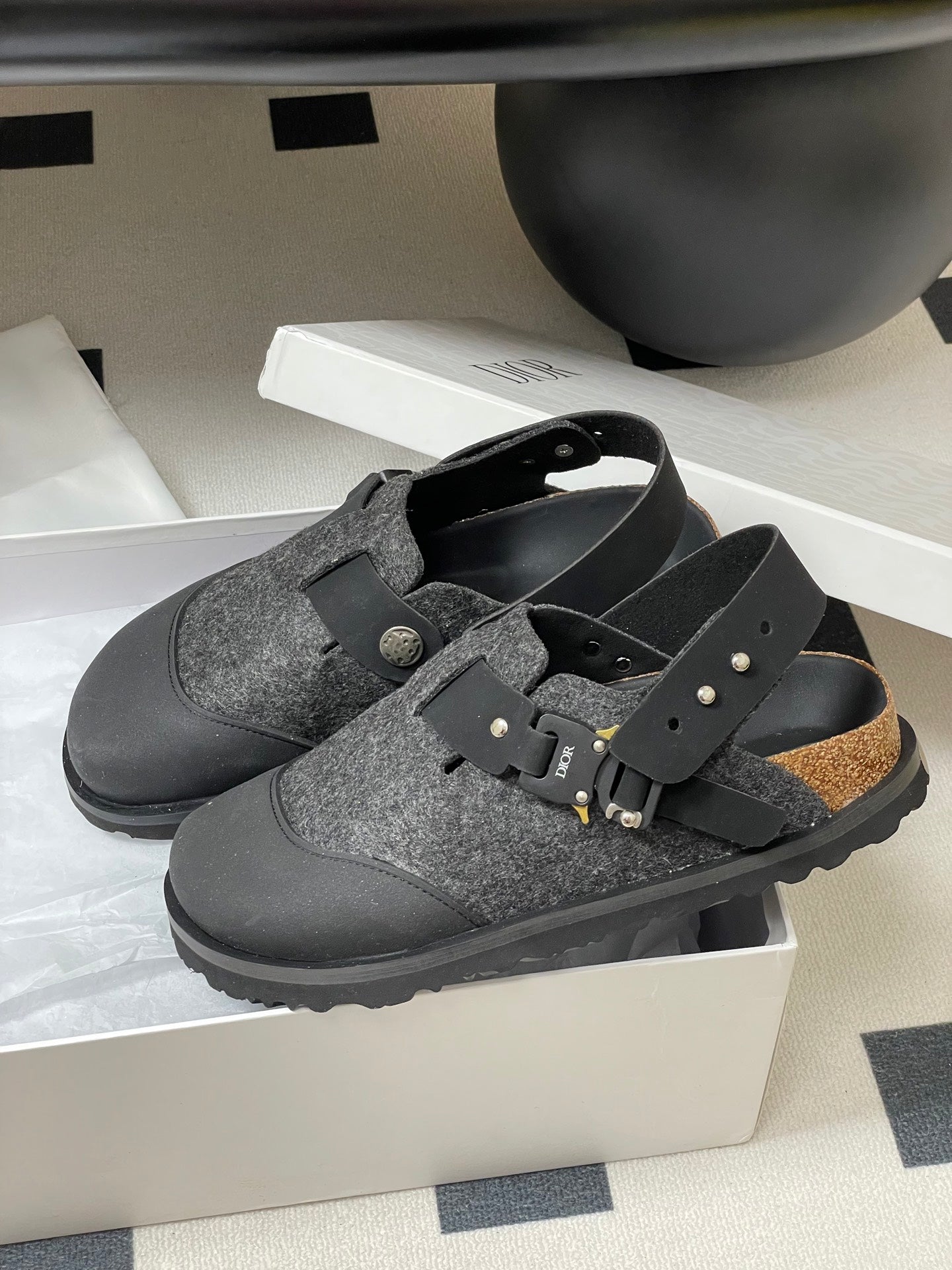 Dior mule sandals in box: gray textured footbed, black straps, gold studs and buckle