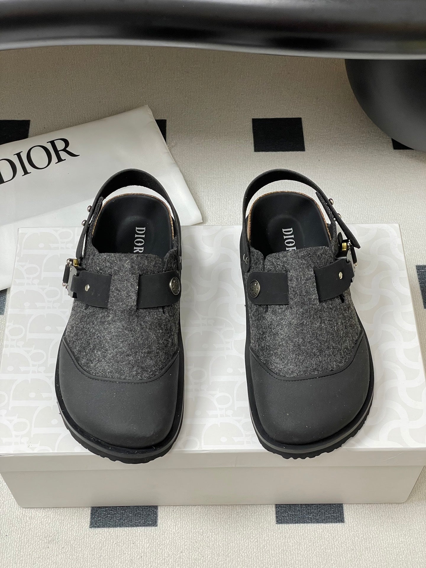 Dior sandals with gray textured uppers and black straps; gold-toned hardware on front