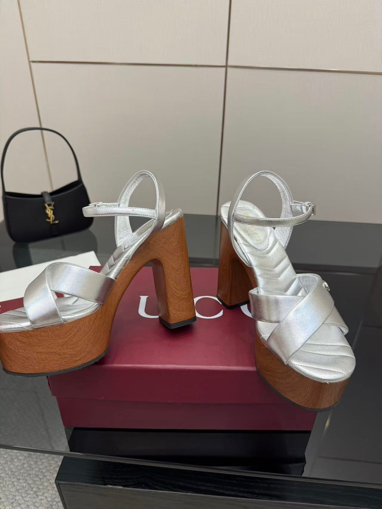 Gucci white heeled platform sandals with crisscross straps on wooden soles