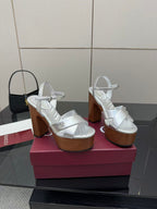 Gucci white heeled platform sandals with crisscross straps and black mini handbag