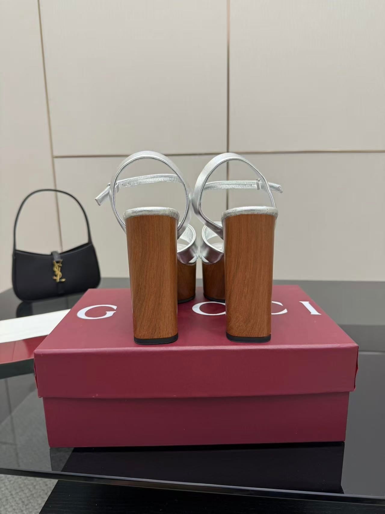 Gucci white platform heeled sandals on tall wooden heels with black mini handbag