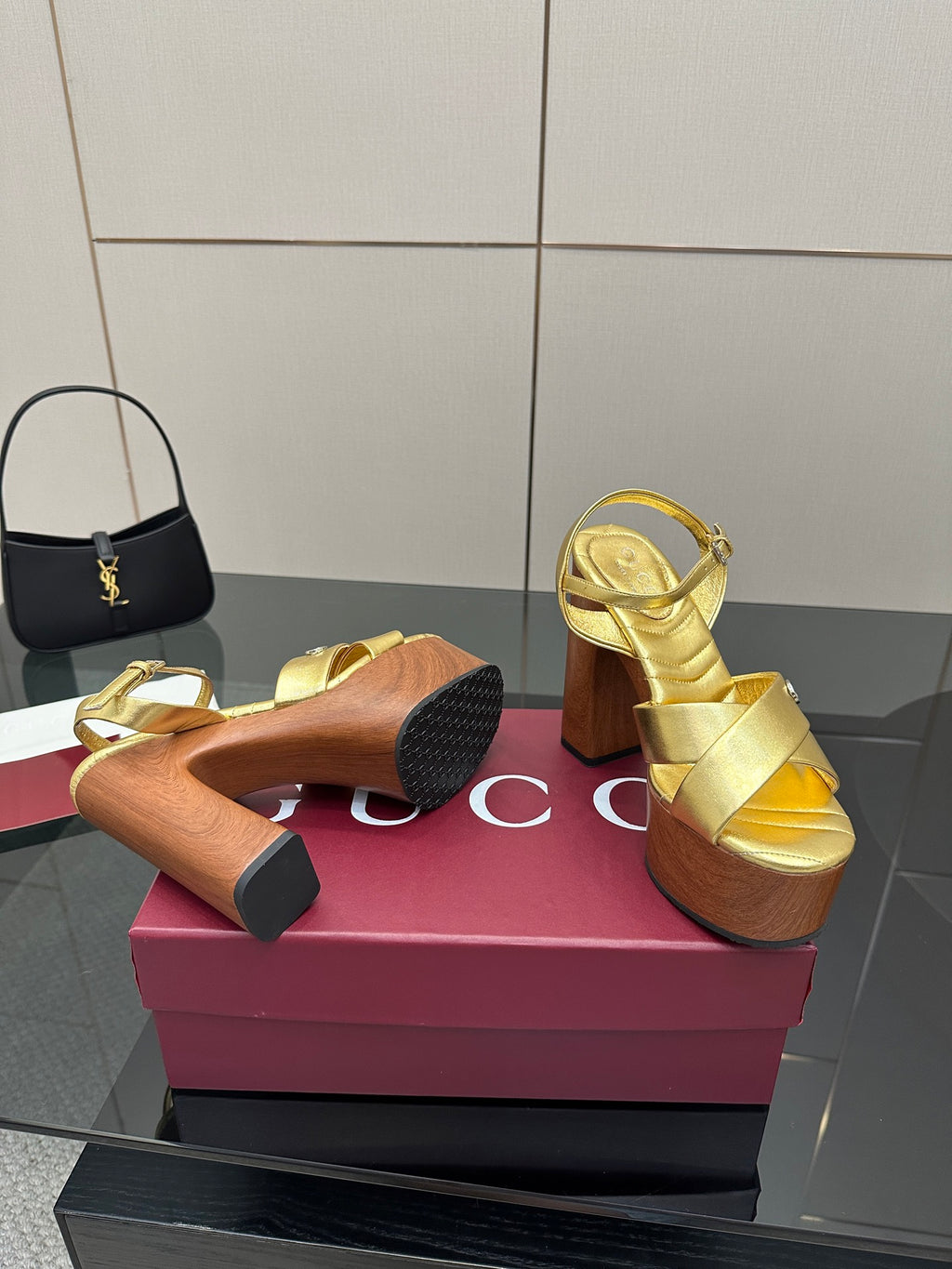 Gucci gold platform sandals underside view, wooden sole and block heel tread
