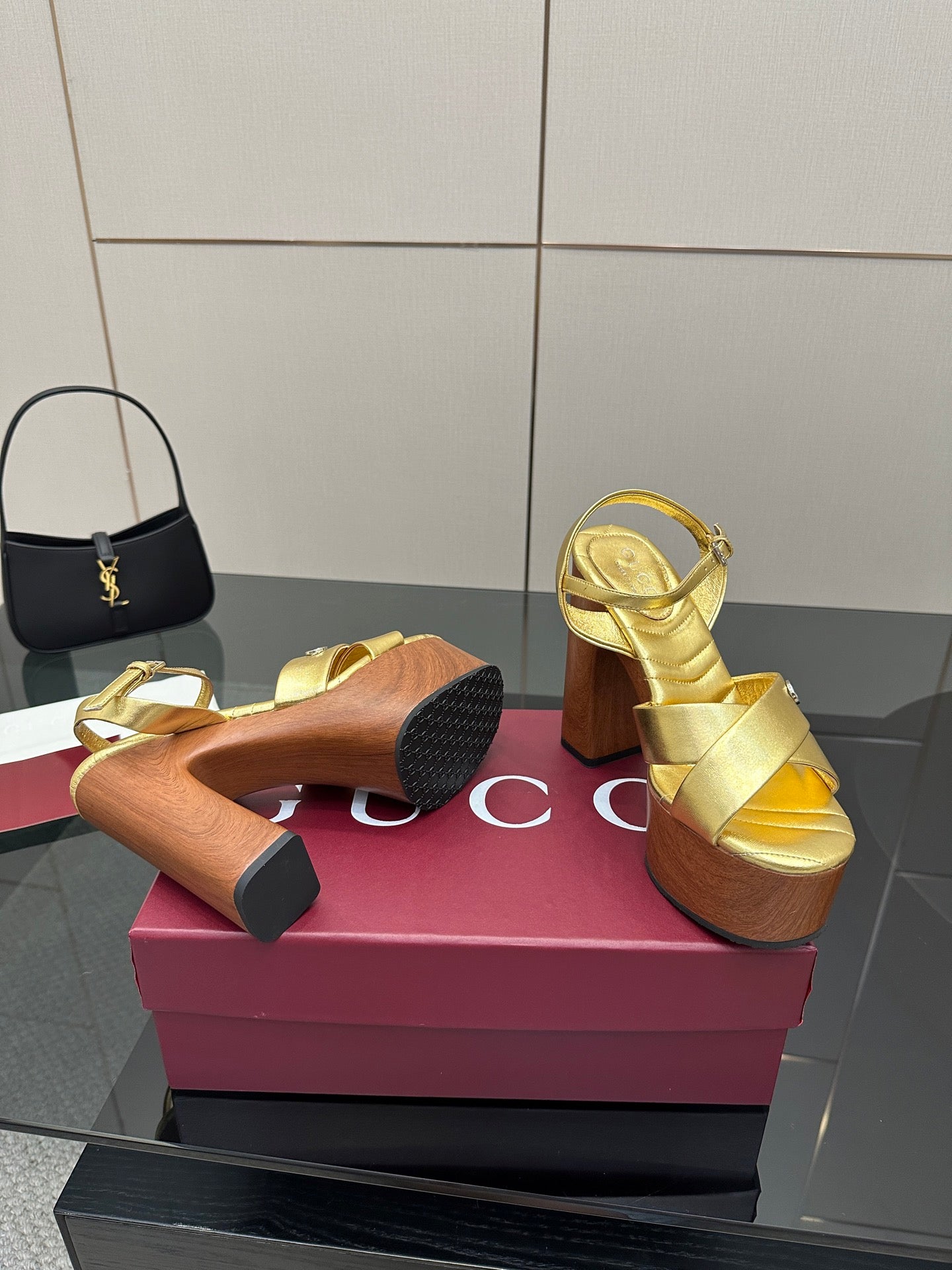 Gucci gold platform sandals underside view, wooden sole and block heel tread