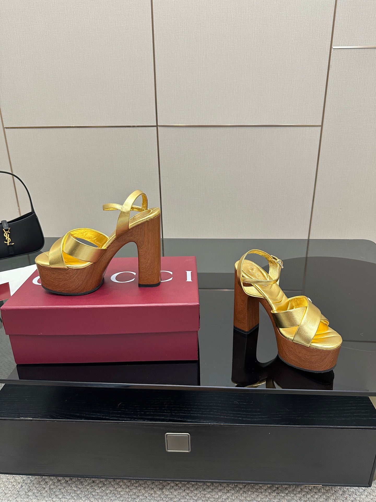 Gucci gold platform sandals with ankle strap and cross straps, on wood platform heel
