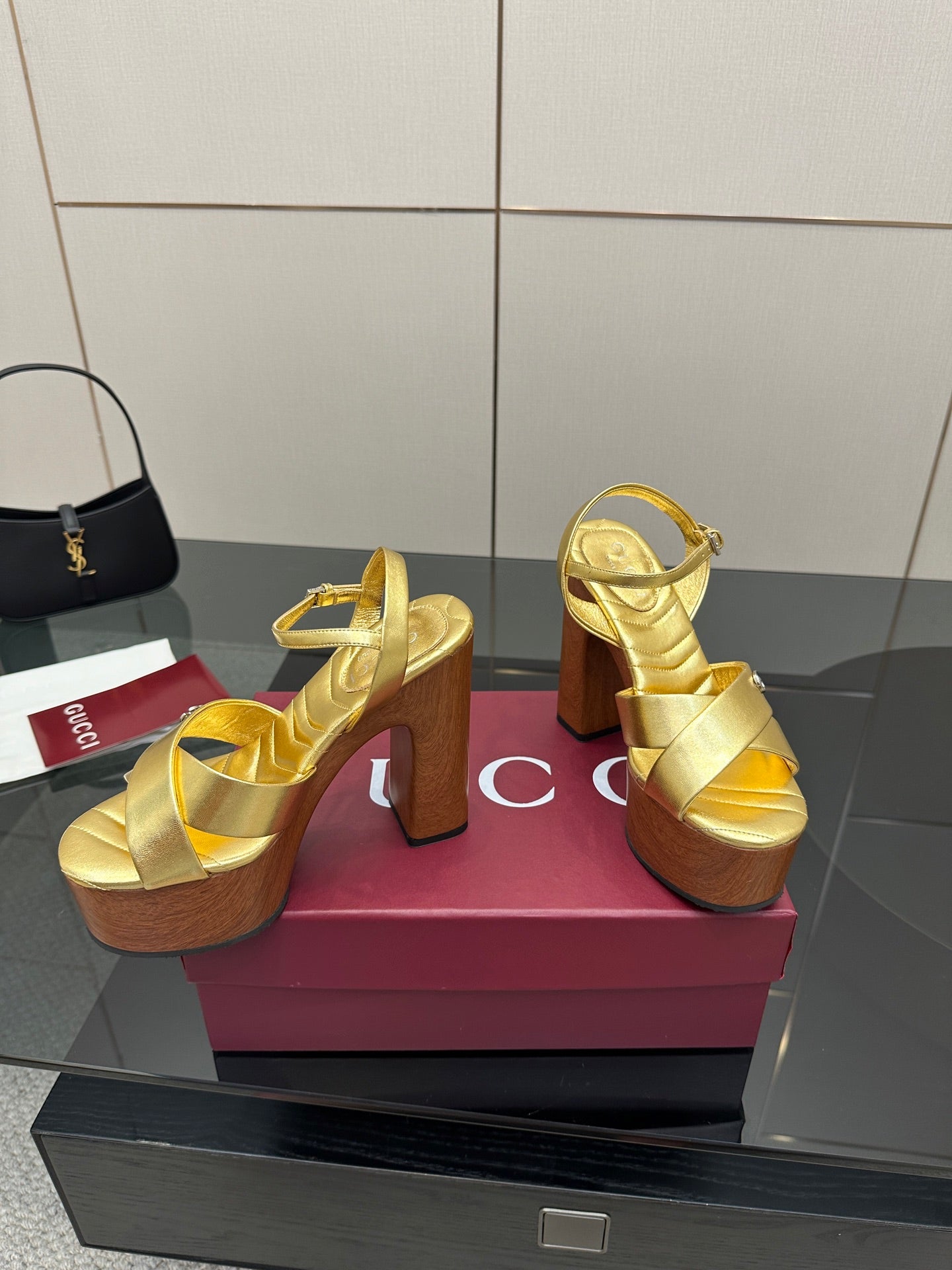 Gucci gold platform sandals with ankle strap and stacked wood heel, open-toe design