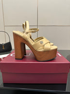 Gucci women's platform sandals, cream straps with open toe and thick wood-tone heels.