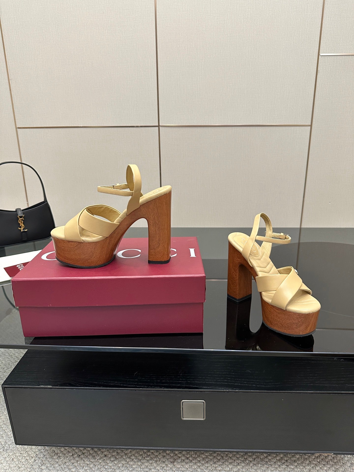 Gucci women's platform sandals, side view with cream straps and cork-covered wedge platform.